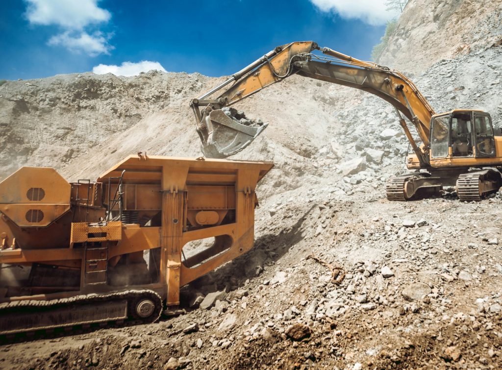 Mining industry - industrial excavator loading rocks and gravel into machinery