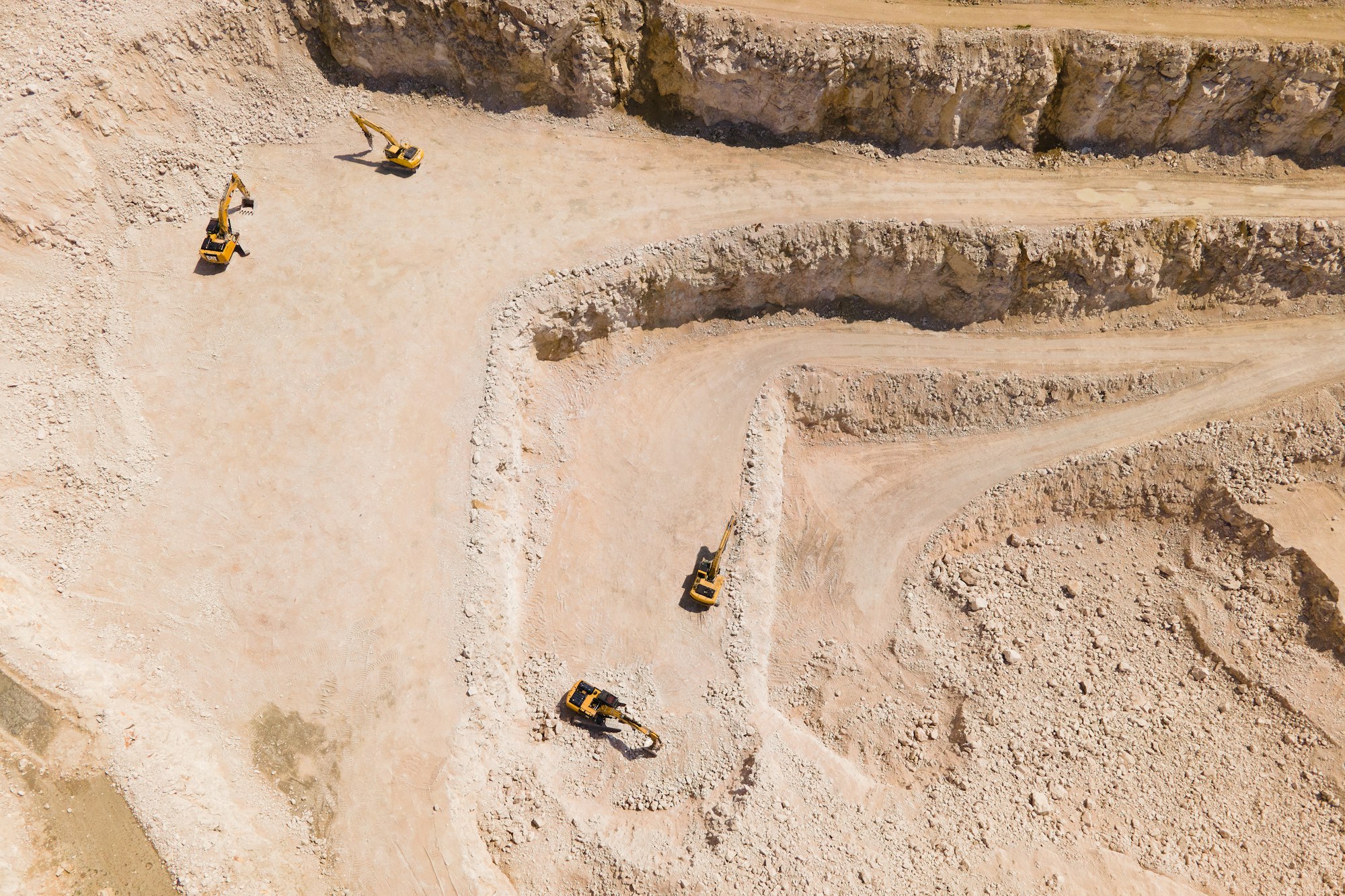 the flight of the drone over a quarry of sand and white stone,